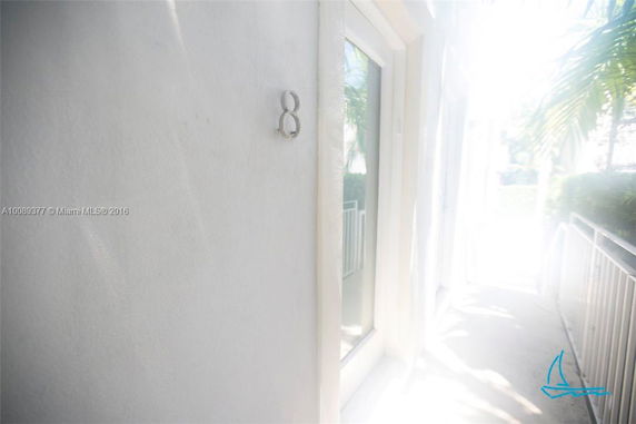 Partial view of a building entrance with a number 8 on the wall.