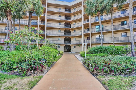 Front view of a multi-story residential building with balconies.