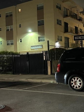 Front view of a multi-story residential building at night.