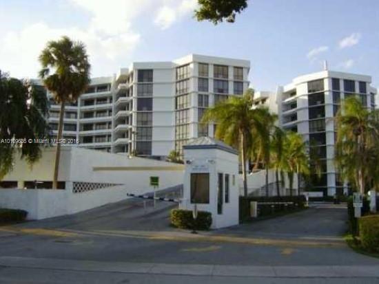 Front view of a multi-story residential building complex with multiple balconies.