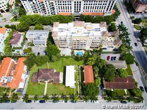 Aerial view of a residential area with multiple buildings and a swimming pool.