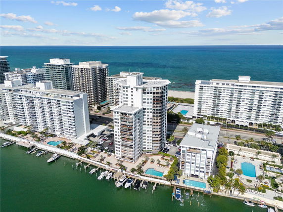 Aerial view of beachfront high-rise buildings with ocean in the background.