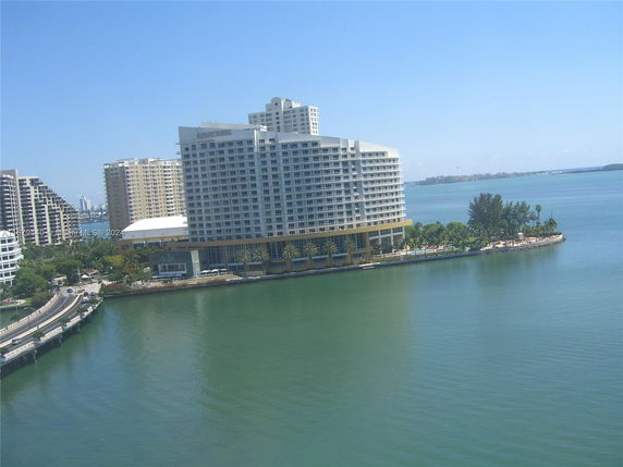 View of large multi-story buildings adjacent to a body of water.