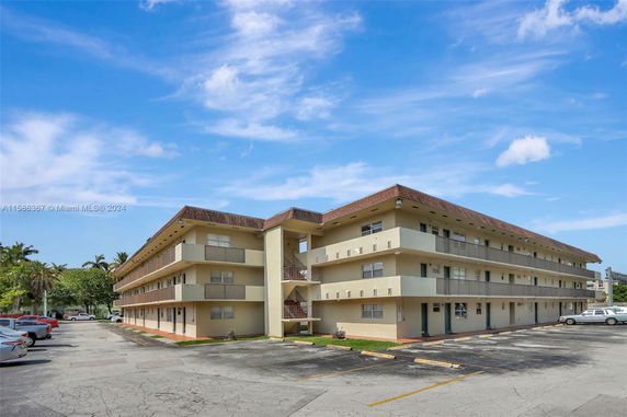 Front view of a three-story apartment building with exterior staircases.