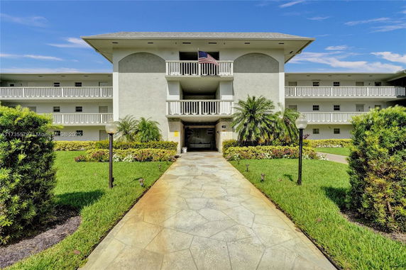 Front view of a multi-story building with balconies.