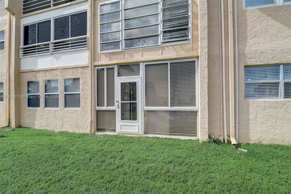 Front view of a building with multiple windows and a central door.