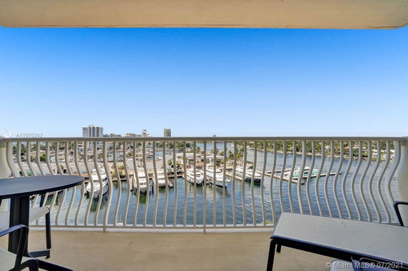 View of waterfront and yachts from a balcony.