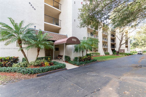 Front view of a multi-story residential building with balconies.