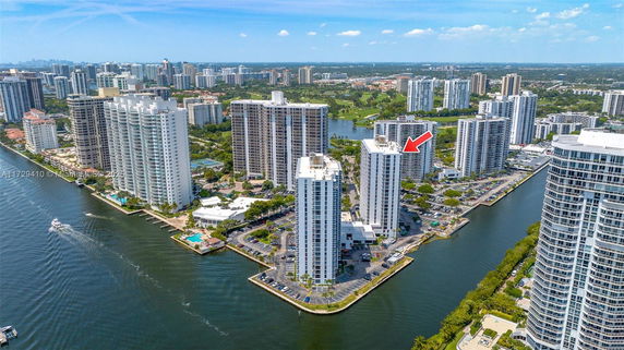 Aerial view of multiple high-rise residential buildings near a waterway.