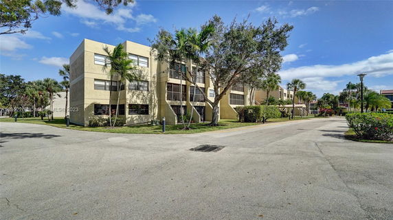Front view of a multi-story residential building with balconies.