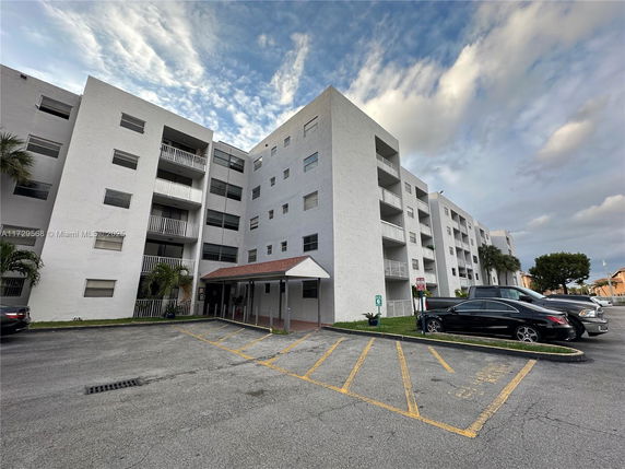 Front view of a multi-story apartment building with balconies.