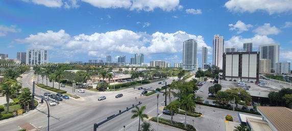 View of a cityscape with multiple high-rise buildings and busy intersections.