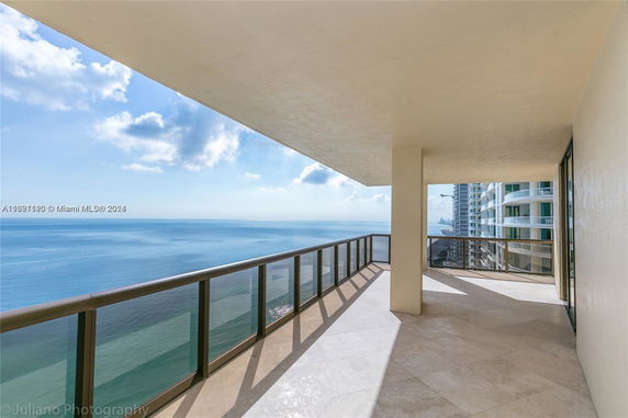 Balcony view overlooking the ocean from a high-rise building.