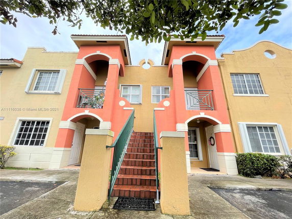 Front view of a multi-story residential building with colorful exterior.