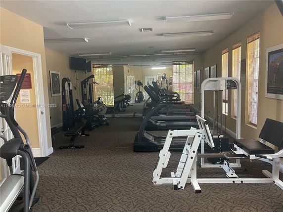 Interior view of a gym area with fitness equipment and treadmills.