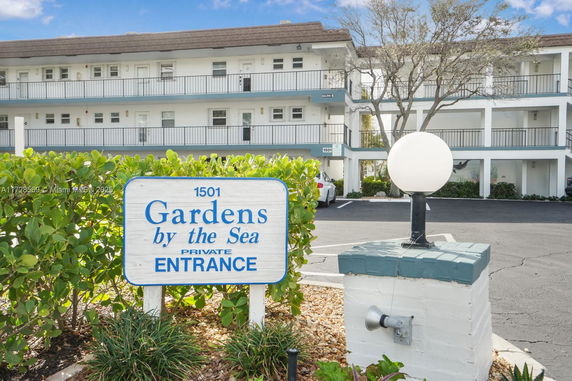 Front view of a multi-story building with balconies and a private entrance sign.