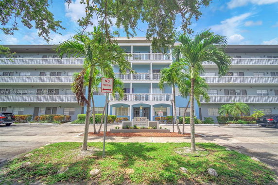 Front view of a multi-story apartment building with balconies.