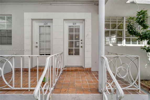 Front view of a building entrance with two doors labeled 103 and 104.