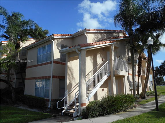 Front view of a two-story building with an external staircase.