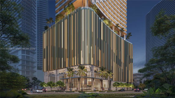 Front view of a modern multi-story building with vertical design elements and glass entrance.