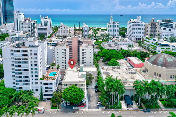 Aerial view of a coastal urban area with high-rise buildings and a beach in the background.