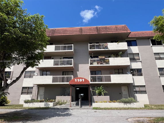 Front view of a multi-story residential building with balconies.