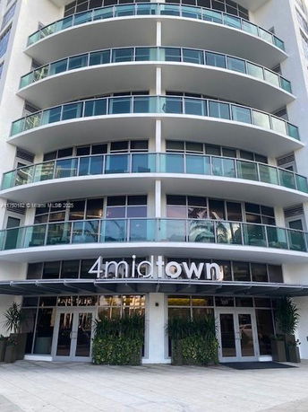 Front view of a multi-story building with glass balconies and entrance labeled 4 Midtown.