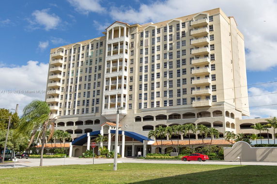 Front view of a multi-story residential building with balconies.