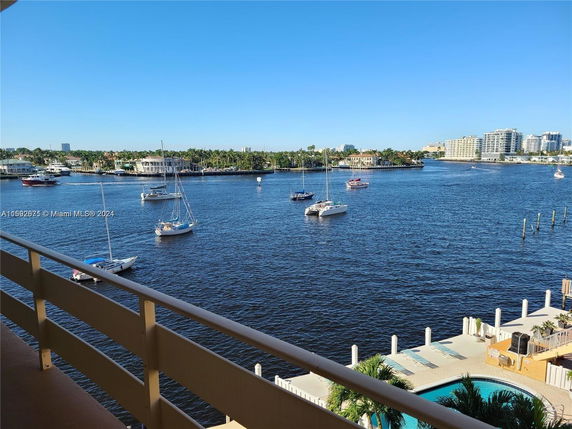 Panoramic view overlooking a body of water with several boats and buildings in the distance.
