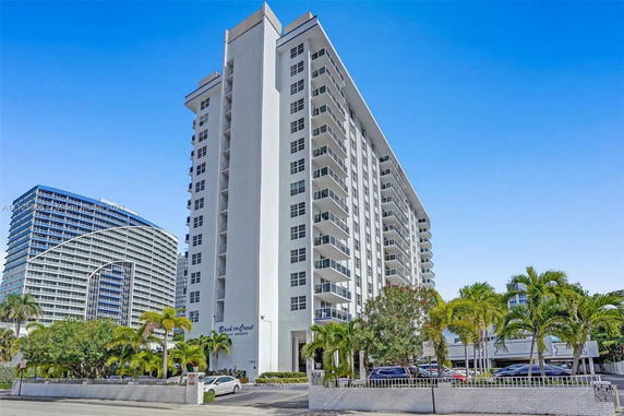 Front view of a multi-story residential building with balconies.