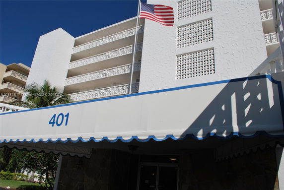 Front view of a multi-story building with a decorative facade and balconies.
