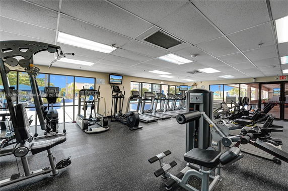 Indoor gym area with various exercise equipment and treadmills.