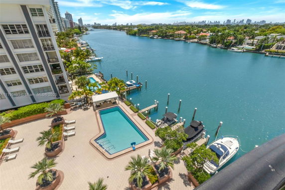 Panoramic view of waterfront area with dock and swimming pool in the foreground.