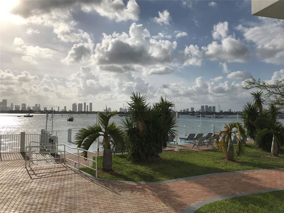 Scenic waterfront view with city skyline in the background.