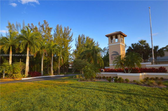 Entrance view of a property with a tower and landscaped surroundings.