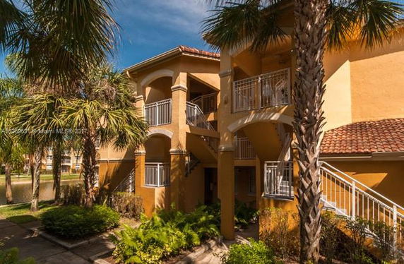 Front view of a two-story building with balconies and stairs.