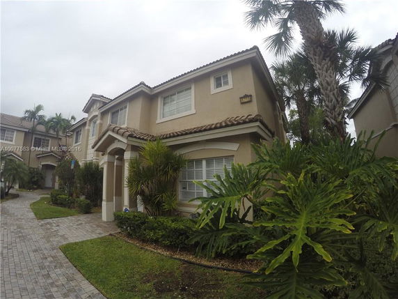 Front view of a two-story house with a tiled roof.