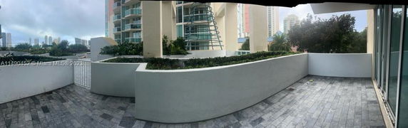 Panoramic view from the balcony of a building with surrounding structures visible.