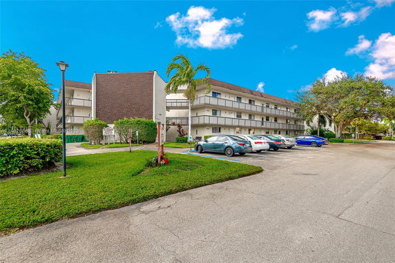 Front view of a multi-story residential building with balconies.