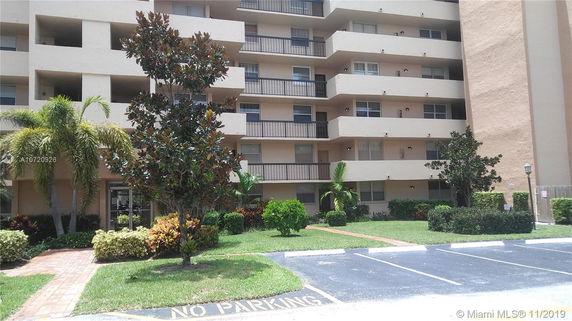 Front view of a multi-story apartment building with balconies.