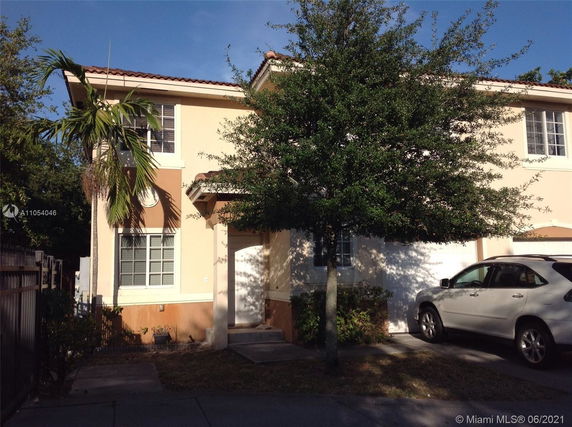Front view of a two-story house with a garage.