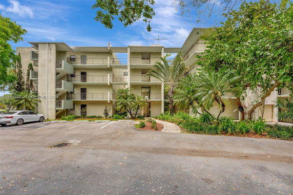 Front view of a multi-story residential building with balconies.