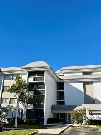 Front view of a multi-story residential building with balconies.