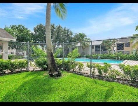 Outdoor view with a swimming pool and surrounding fence.