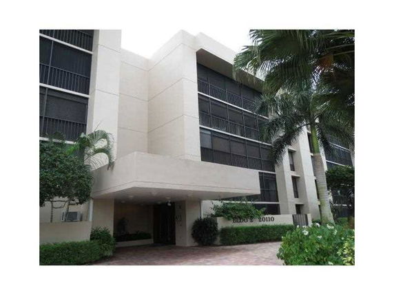 Front view of a multi-story residential building with balconies.