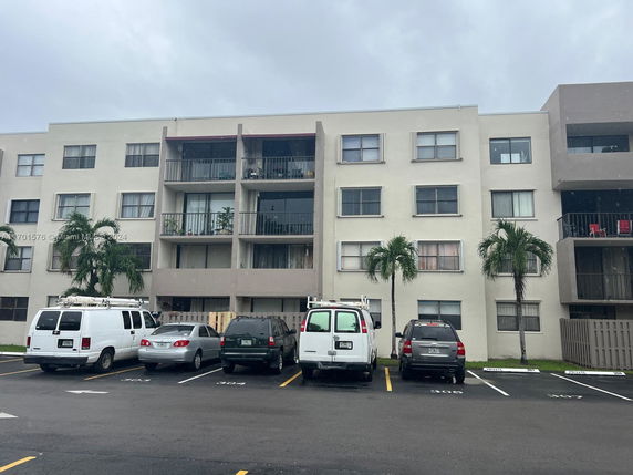 Front view of a multi-story apartment building with balconies.