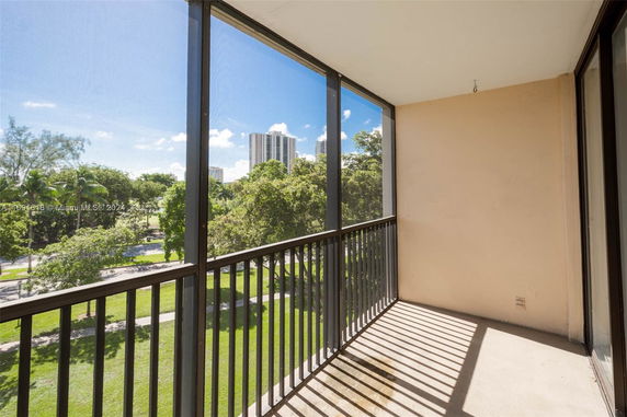Balcony view with buildings and trees in the background