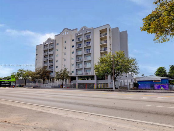 Front view of a multi-story apartment building with a modern design.
