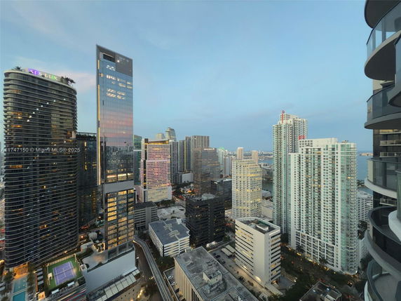 View of tall modern skyscrapers in an urban cityscape during early evening.