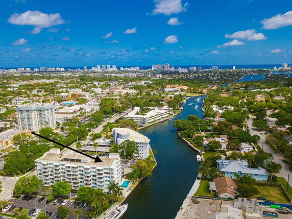 Aerial view of a residential area with multiple buildings near a canal.